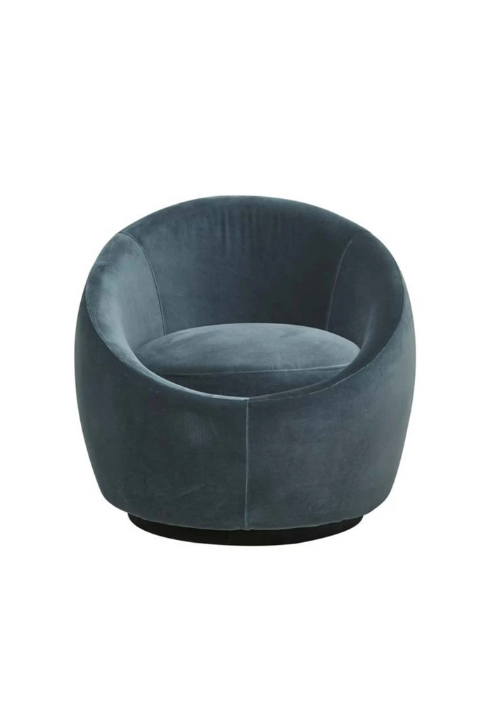 Bold round occasional armchair fully upholstered in charcoal blue velvet with a round black base on white background