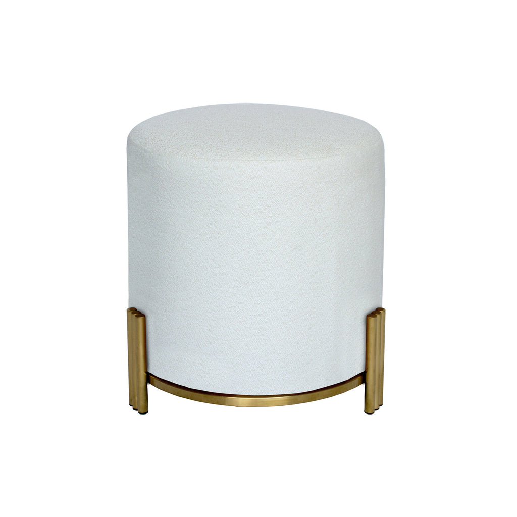 Round Ottoman upholstered in textured white fabric with brushed gold metal base and three ribbed legs on white background