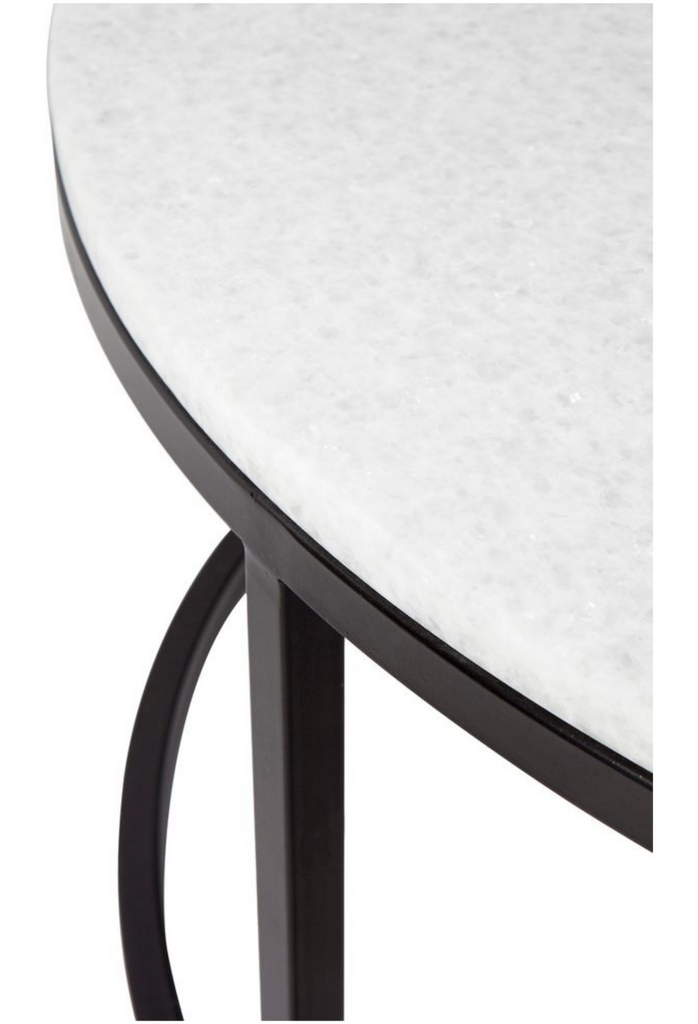 Two Round Nesting Coffee Tables with a White Quartz Looking Stone Top and a Sleek Black Metal Frame on a White Background