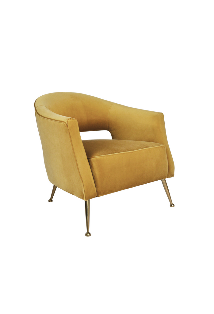Yellow honeycomb coloured velvet tub style chair with open back and brass gold legs on a white background