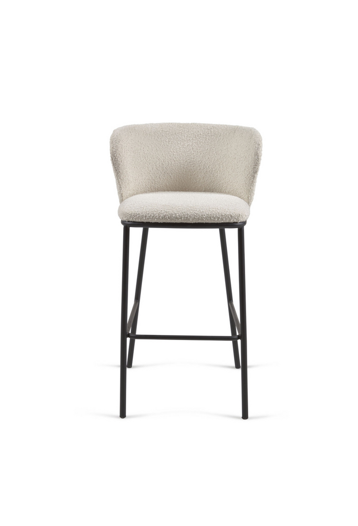 High bar stool with shearling upholstery a curved back rest and black metal legs on a white background