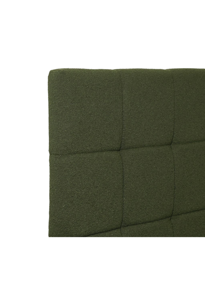 Modern padded bedhead fully upholstered in a dark green plush fabric with square shaped stiching details on a white background