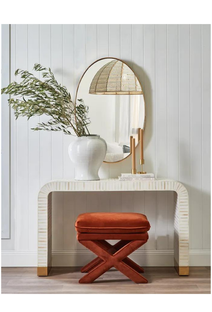 Modern curved console table with white bone inlay creating white and bone striped look and brass clad base