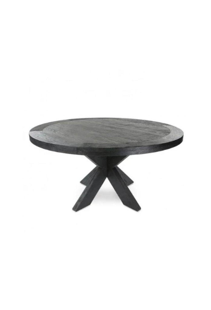 Solid black oak dining table with a large round table top on chunky geometric shaped legs with sharp edges