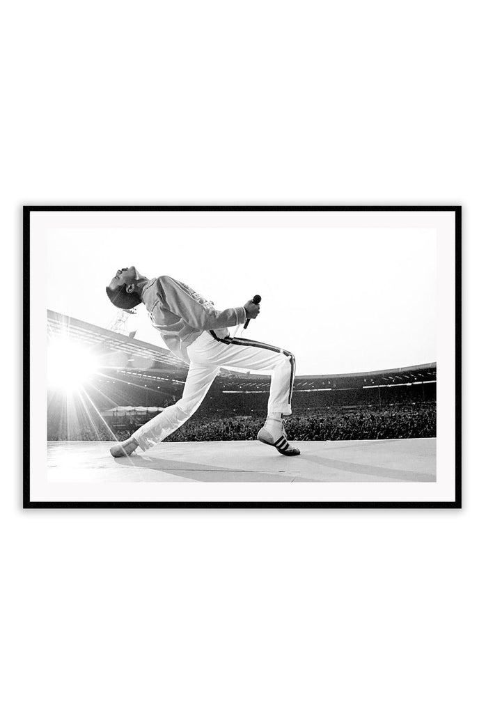 Black and white photography print of Freddie Mercury performing at live aid leaning backwards in front of the crowd.