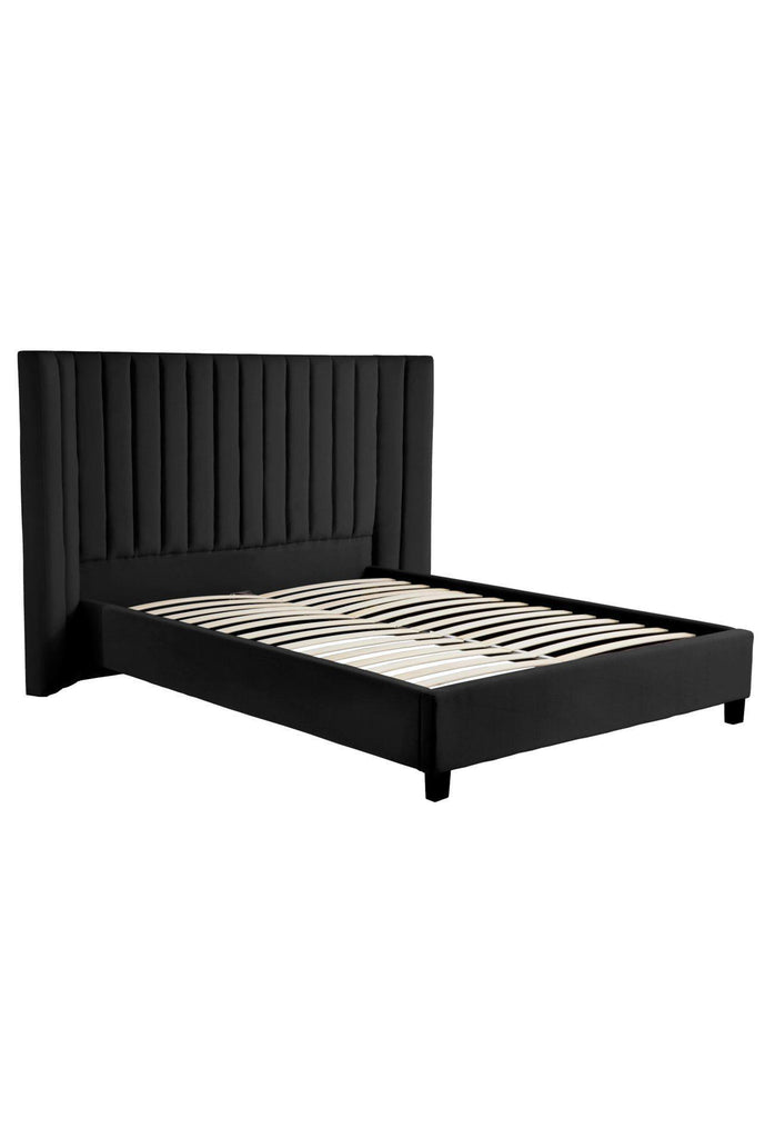 Black velvet panelled bed with a large curved bedhead featuring plush velvet panels on a white background