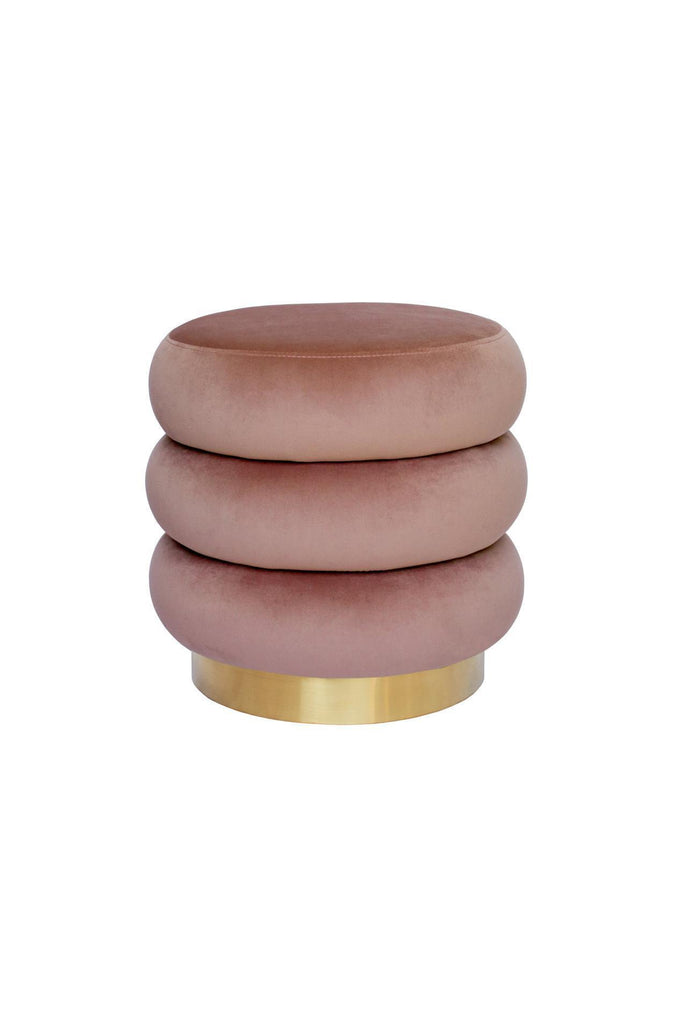 Round ottoman with three layers creating ribbed shape upholstered in blush pink velvet with brushed gold base