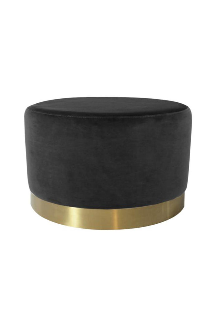 Large round ottoman fully upholstered in black velvet with a brushed gold base on a white background