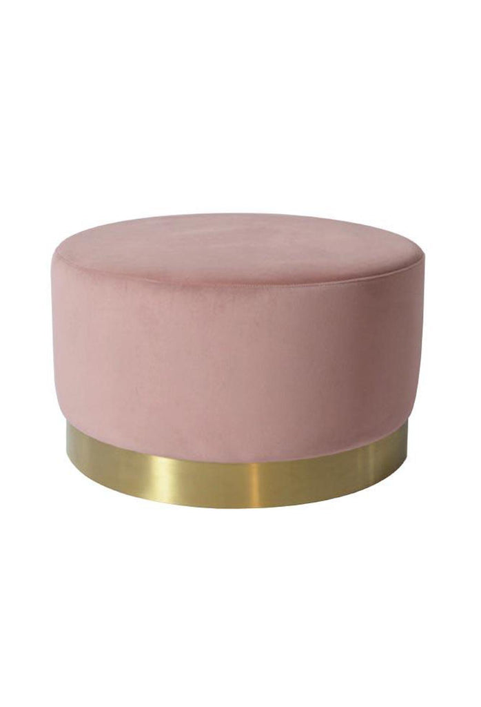 Large solid round ottoman fully upholstered in a light blush pink coloured velvet with a brushed gold base on a white background