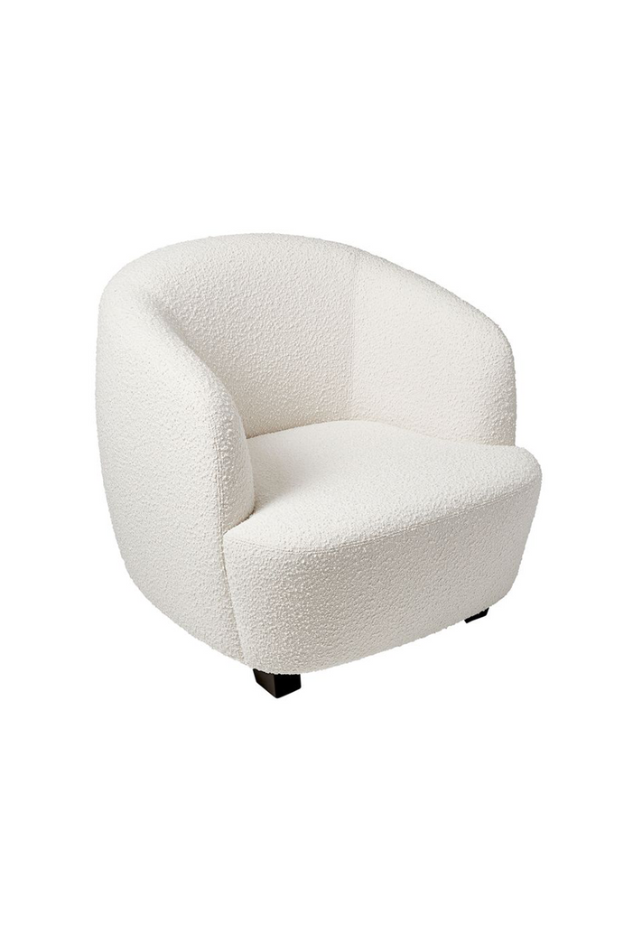Modern curved tub style armchair upholstered in cream white boucle with black feet on a white background