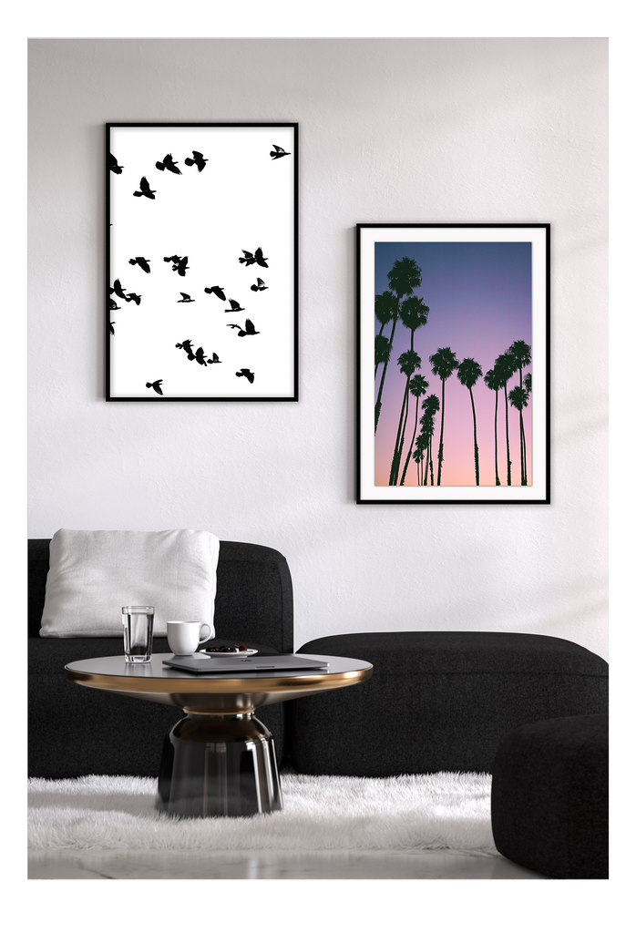Photography coastal print with shadows of palm trees on a purple, pink and orange sunset background.