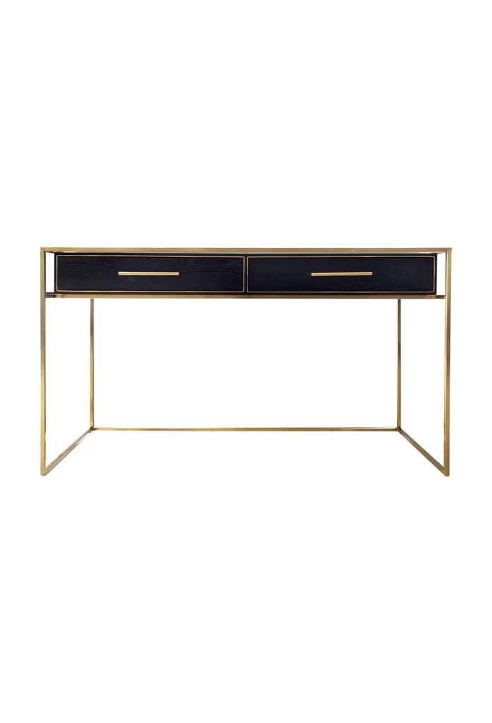 Modern Desk with a sleek gold metal frame and two black ash veneer top drawers covered by a glass table top on a white background