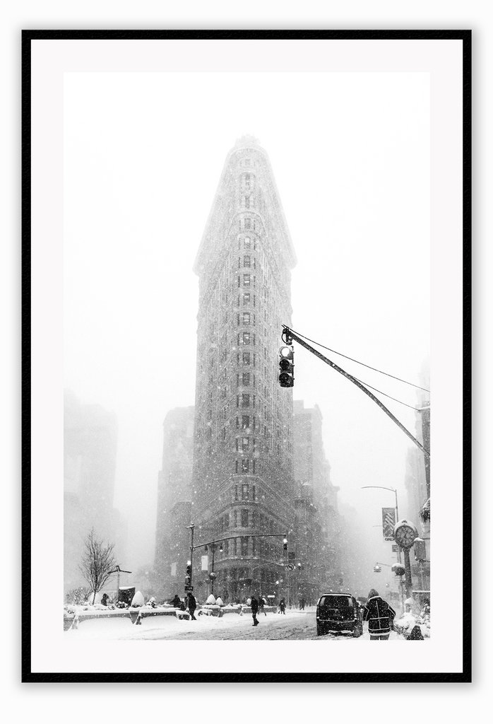 A black and white urban wall art with a snowy city street corner in winter