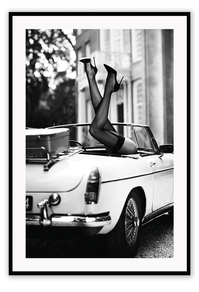 Fashion photography with womans legs coming out of a vintage car black and white lingerie sexy  