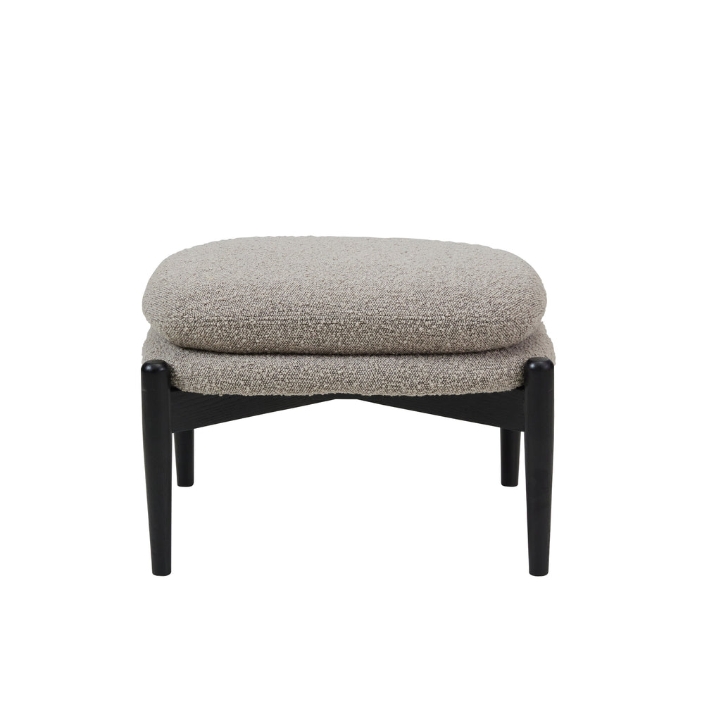 Ottoman stool with two piled up seating cushions in beige boucle and a crossed black wooden base on white background