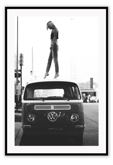 Woman dancer on top of car VW combi van in black and white portrait vintage 