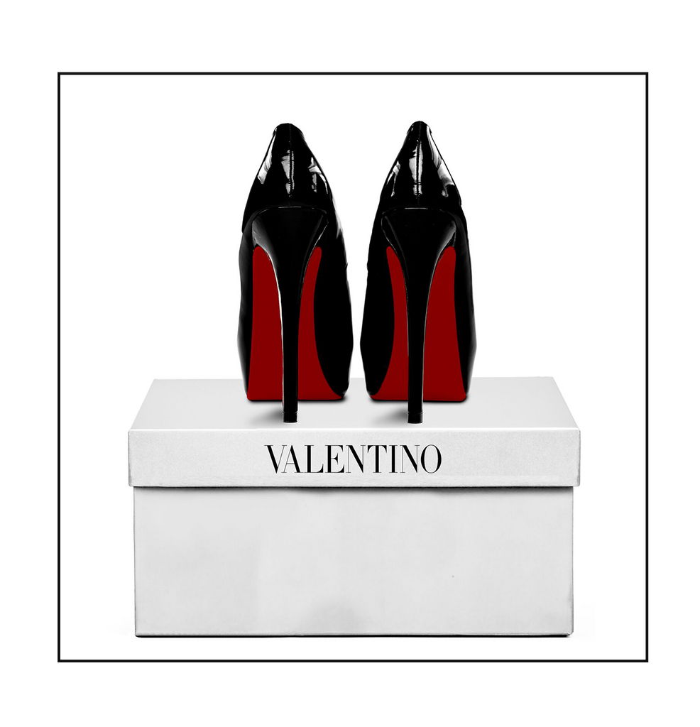 Square photography of red bottom black heels on top of a white valentino box on a white background  
