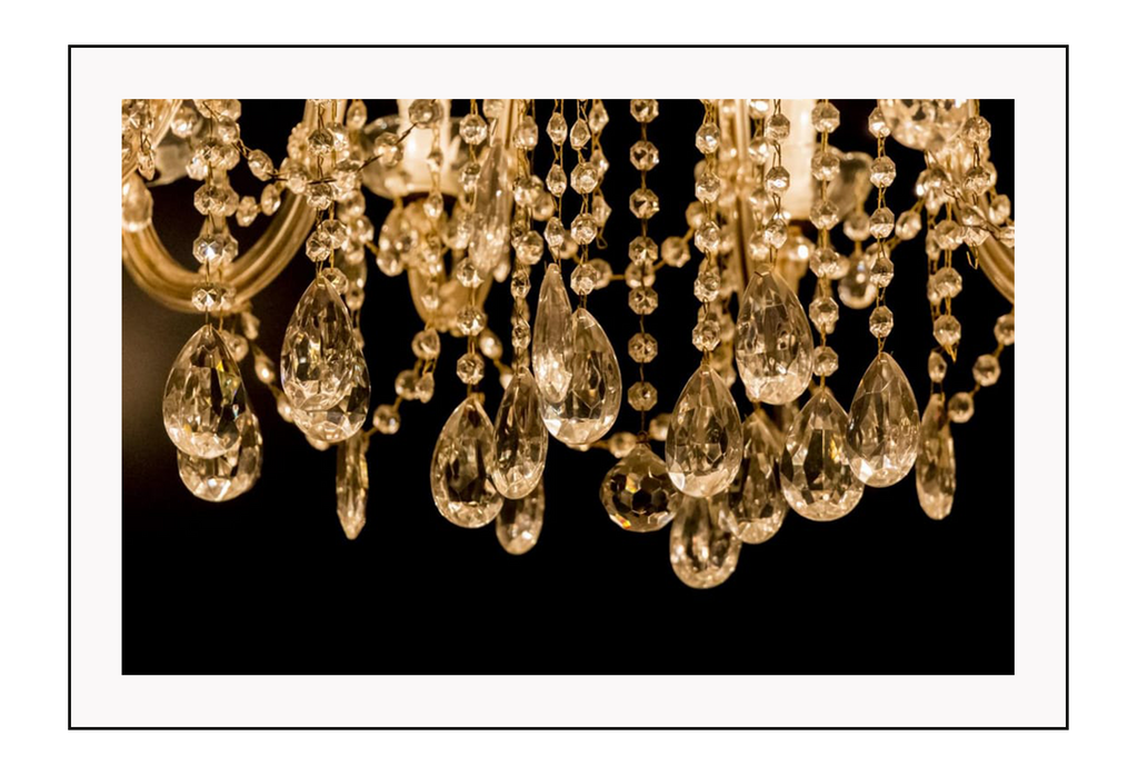 Close up photography of gold crystal chandelier with black background 
