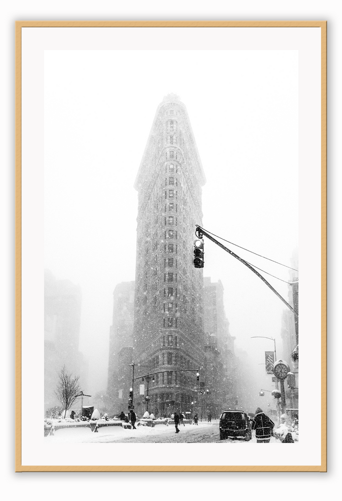 A black and white urban wall art with a snowy city street corner in winter