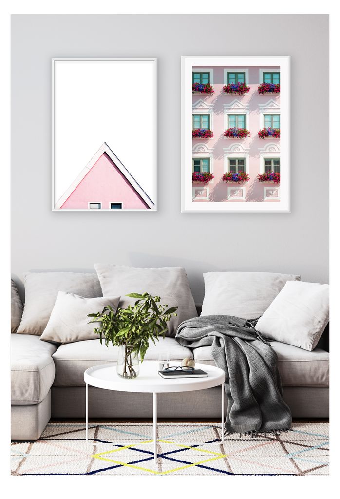 An italian architecture wall art with a pink classic European building facade and floral boutique on balconies. 