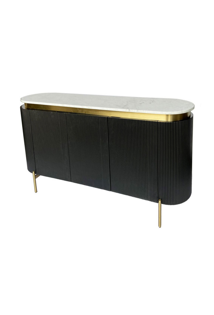 Black Oval shaped buffet with fluted front, a white marble top and four gold iron legs on a white background