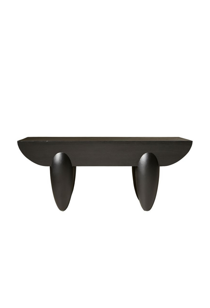 Hand crafted black pine coffee table with chunky curved table top and four oval shaped legs on white background