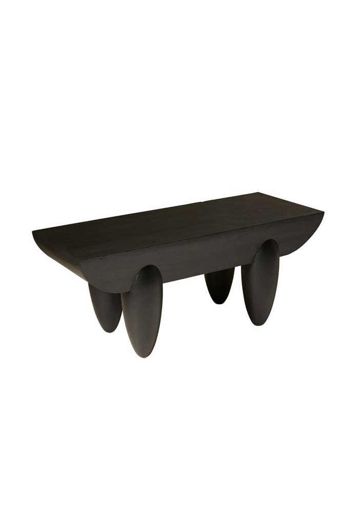 Hand crafted black pine coffee table with chunky curved table top and four oval shaped legs on white background