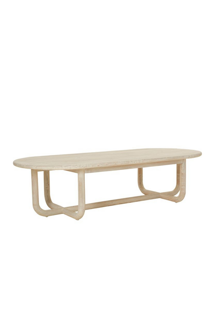 Hand crafted natural pine wood coffee table with oval table top and chunky curved legs connecting to a crossed base