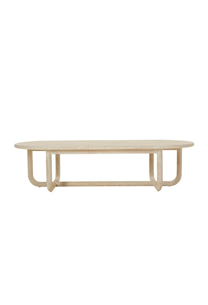 Hand crafted natural pine wood coffee table with oval table top and chunky curved legs connecting to a crossed base
