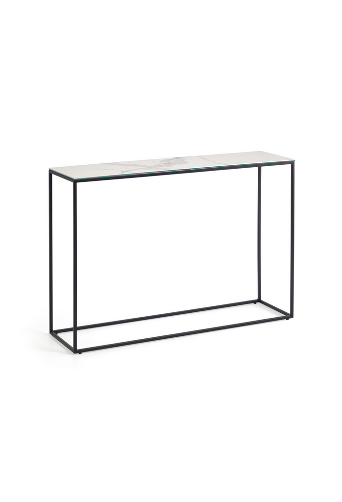 Minimalistic narrow console table with a rectangular white ceramic top and a thin black metal frame on a white background