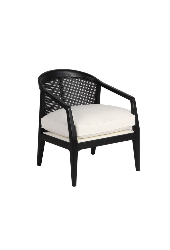 Black occasional armchair with a curved back rest featuring rattan detailing and a white linen seat cushion
