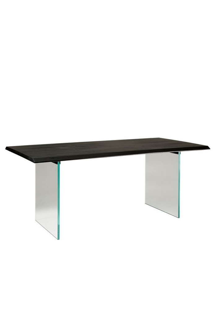 Minimalistic rectangular dining table featuring straight lines and sharp edges with a black wooden table top and two glass legs