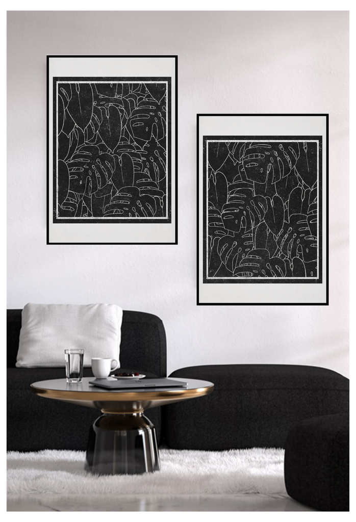Modern scandi style print with white outlines of monstera leaves on a black background surrounded by a cream border.