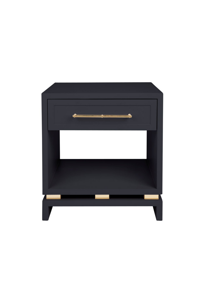 Black Bedside Table with a top drawer featuring Gold Handles and Detailing and a storage compartment in the middle on a white background