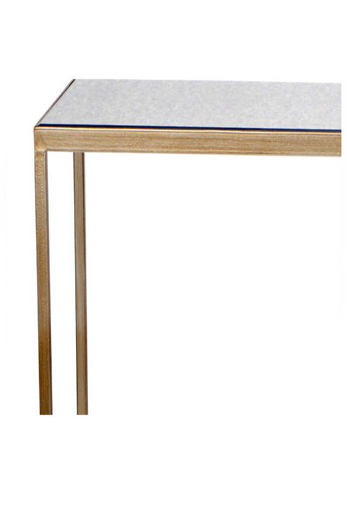 Two tier rectangular console table with sharp edges and an antique gold iron frame featuring a mirrored top and shelf