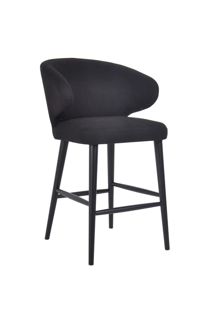 Black linen upholstered kitchen stool with wing back style arms and black timber legs on a white background