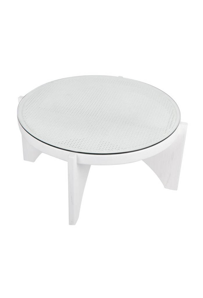 White Wooden Coffee Table with Circular White Rattan and Glass Top and Arched Base on a White Background