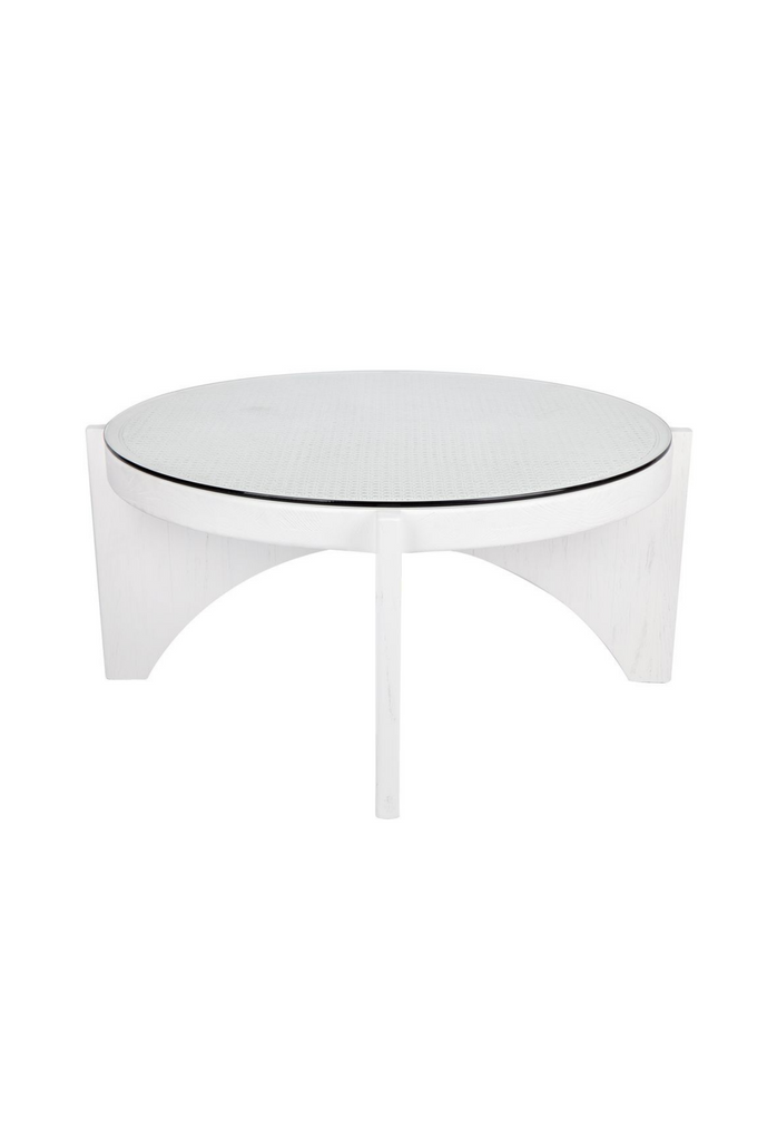 White Wooden Coffee Table with Circular White Rattan and Glass Top and Arched Base on a White Background