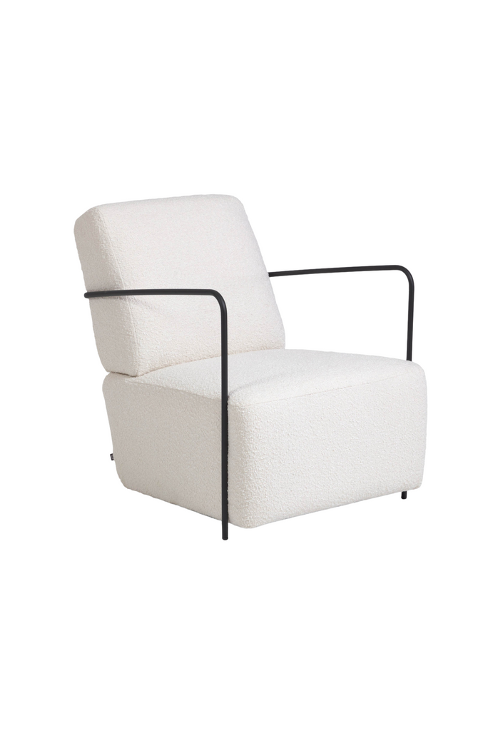 White boucle armchair with black metal frame and wire arm rests on a white background