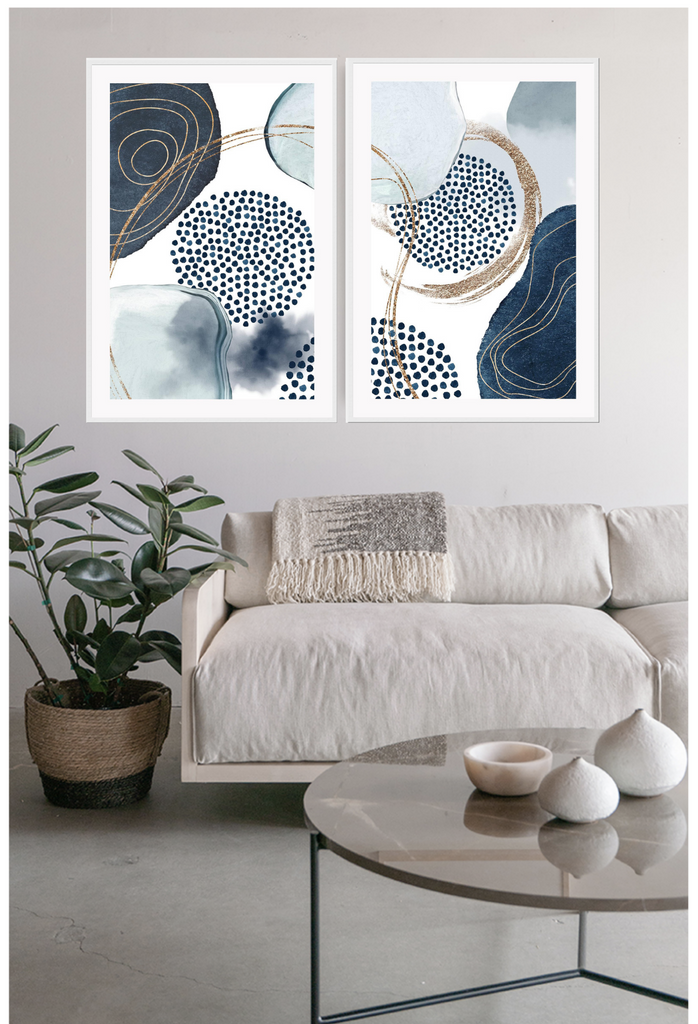 Abstract art print featuring blue and navy watercolour shapes overlapping connected with gold lines on a white background.