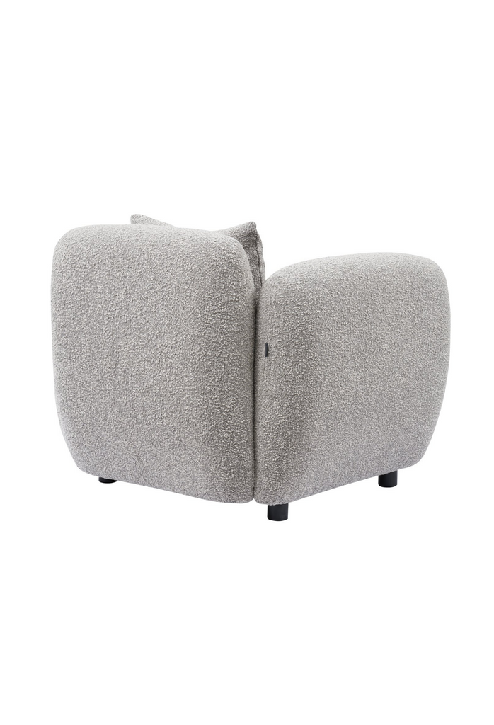 Chunky Armchair with generous back and arm rests fully upholstered in wheat grey boucle with matching cushion and round matte black feet