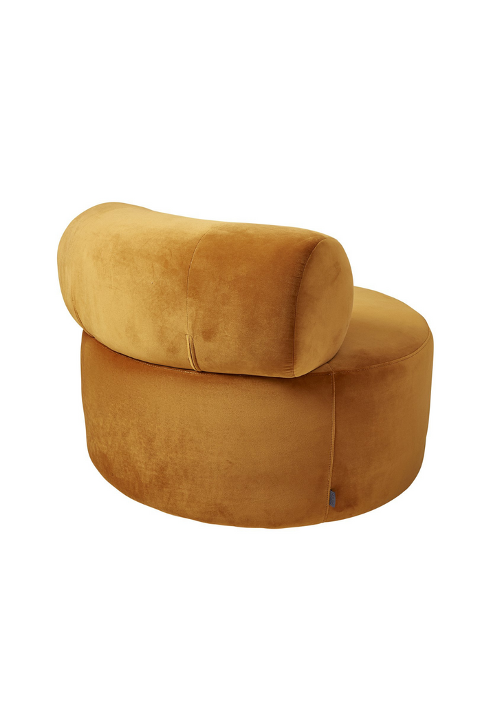 Chunky round swivel chair in orange cognac velvet with matching curved back rest on white background