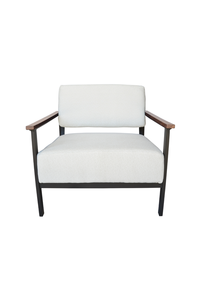 Contemporary armchair with a black metal frame, walnut wood arm rests and cream white textured upholstery on a white background