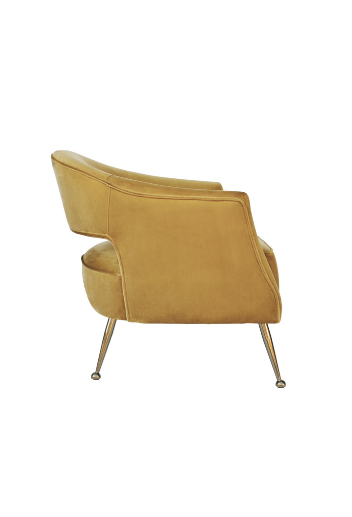 Yellow honeycomb coloured velvet tub style chair with open back and brass gold legs on a white background