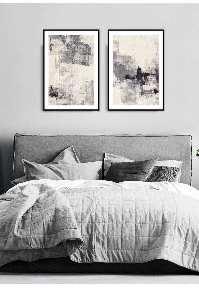 Textured abstract art print with scattered grey and black brushstrokes in the center on an off-white background.
