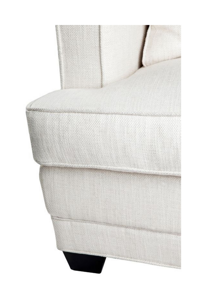 White upholstered 3 seater sofa with black timber legs