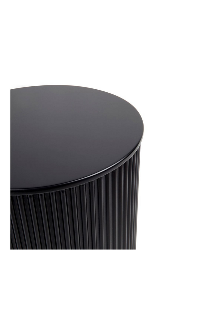 Contemporary black round side table with textured facade