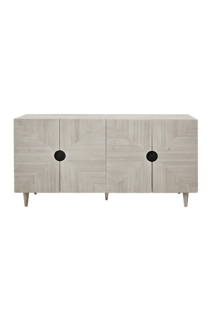 Rectangular Sideboard with four doors featuring geometric carvings and cut out handles in white wash finish pine wood on white background