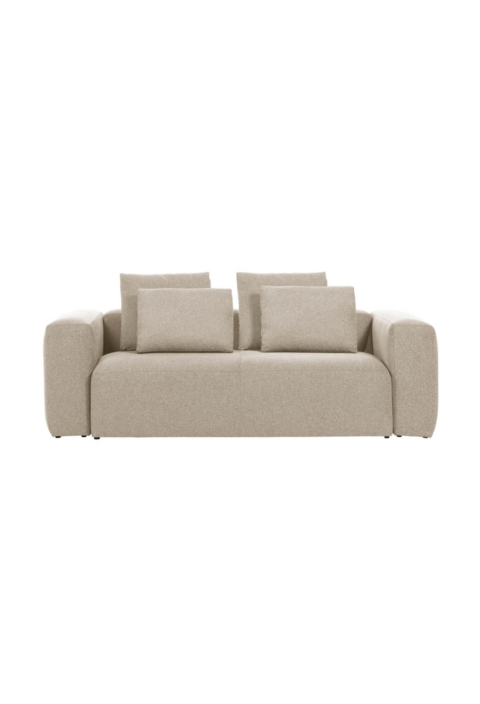 Modern 2 seater in clean geometric shape with sharp edges and one large seat cushion fully upholstered in a beige fabric