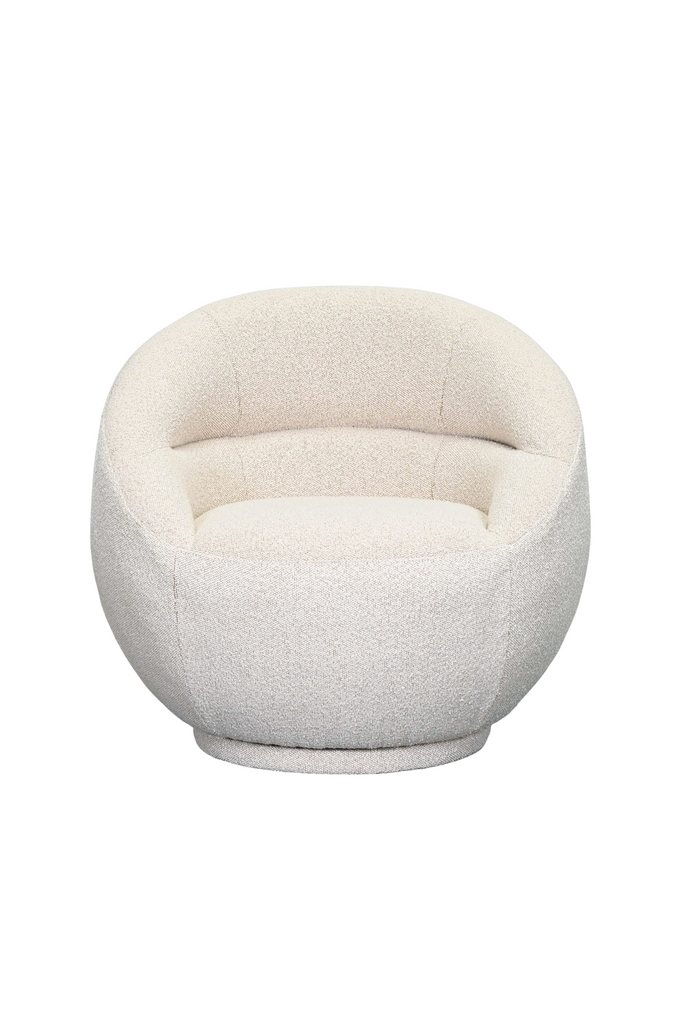 Compact armchair fully upholstered in a cream boucle like fabric with curved seat and back rest on an upholstered base